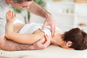 Osteopath performing a technique for relieving shoulder pain